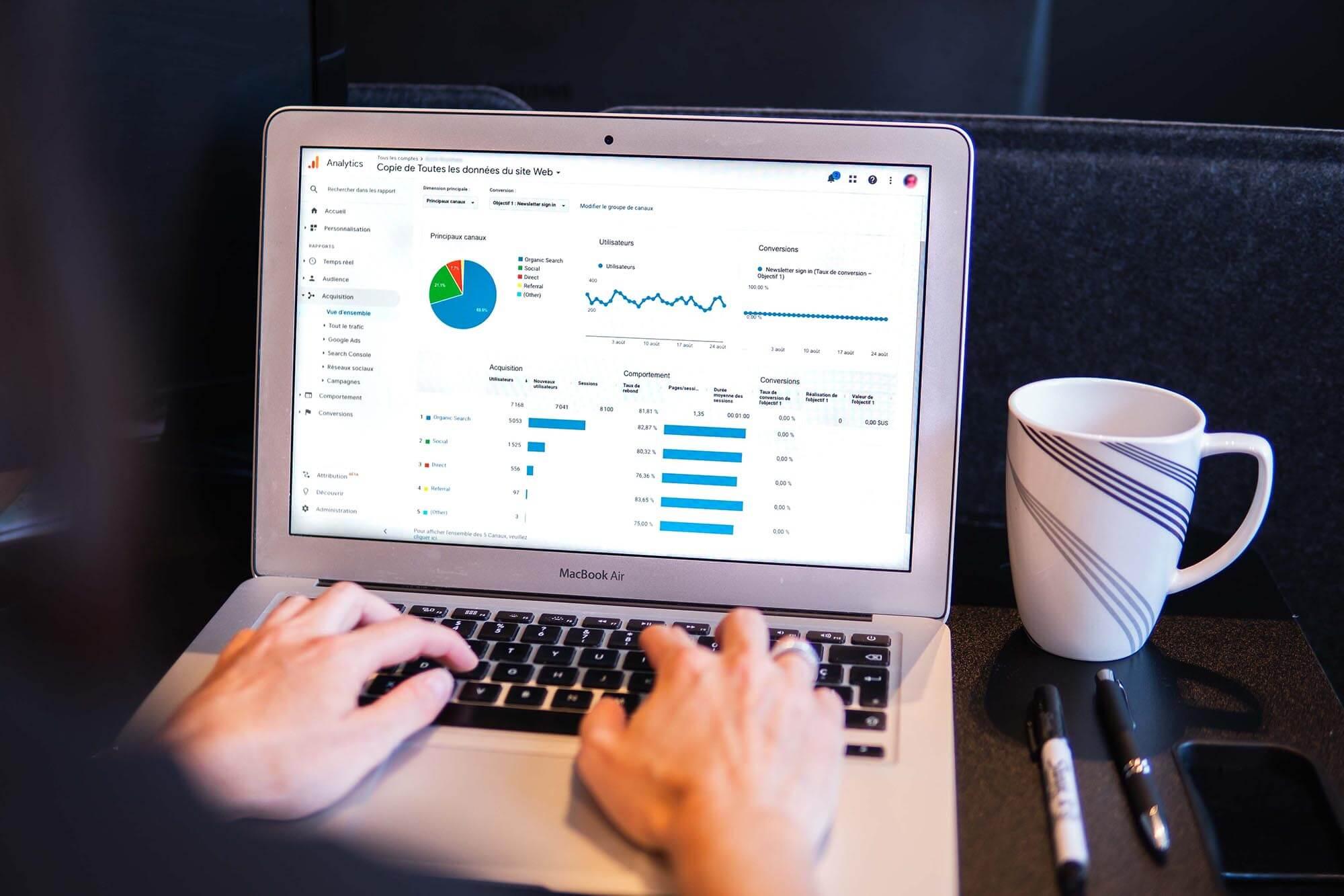 Photo of someone on a laptop viewing site analytics