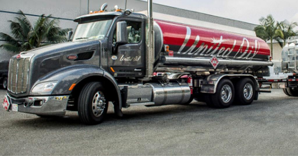 A parked United Oil gas truck with an extra tanker being towed in the back.
