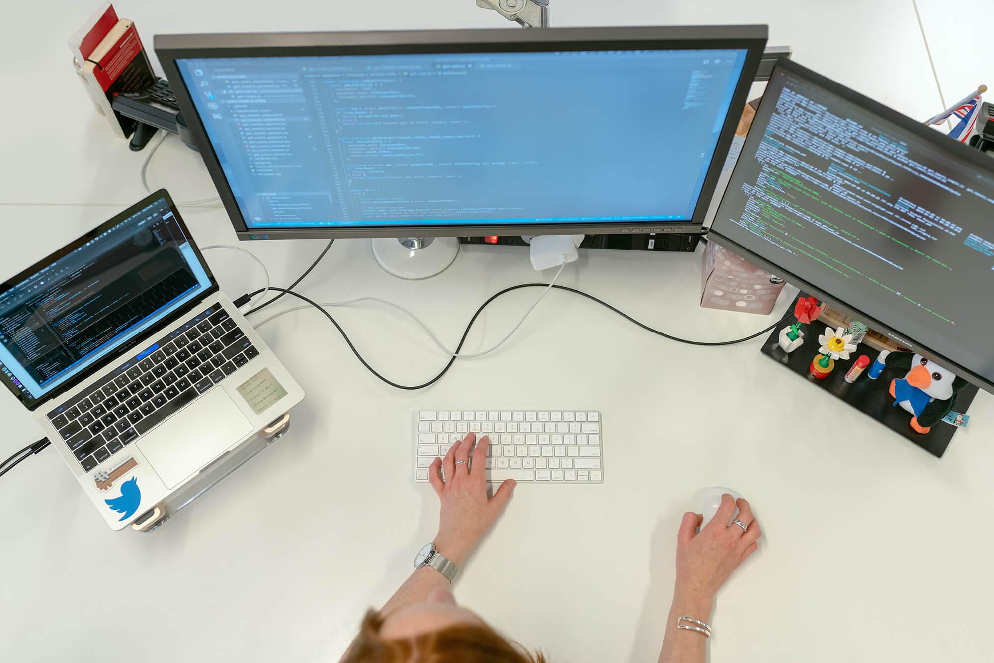 Overview of person's desk and her computer monitors turned on.